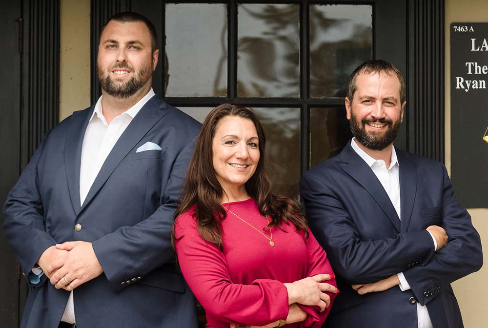 Group photo of attorney Andrew M. Shalna, staff member and attorney Ryan Mitchell